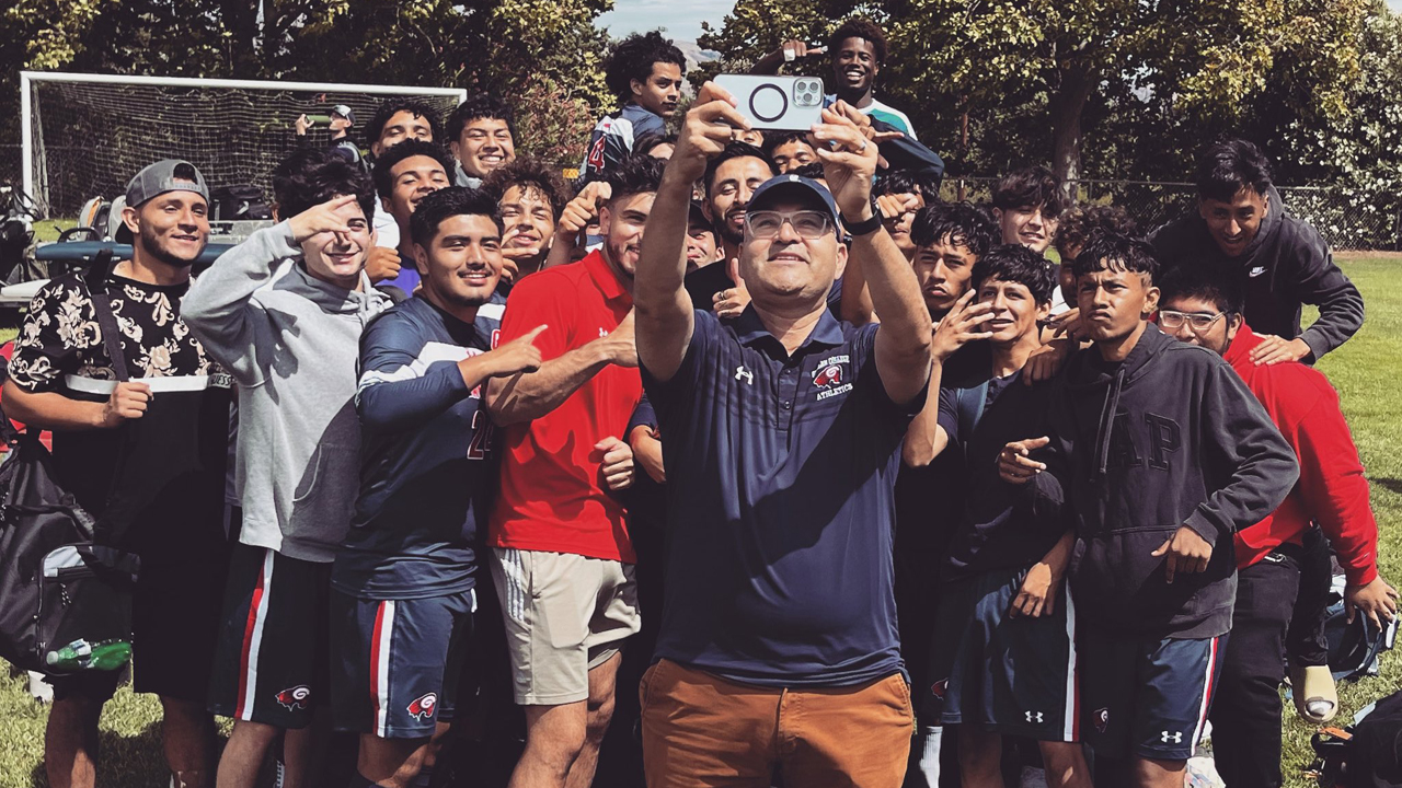 Gavilan College President Dr. Pedro Avila takes a photo with the men's soccer team following the Rams' 6-1 win over Redwoods.
